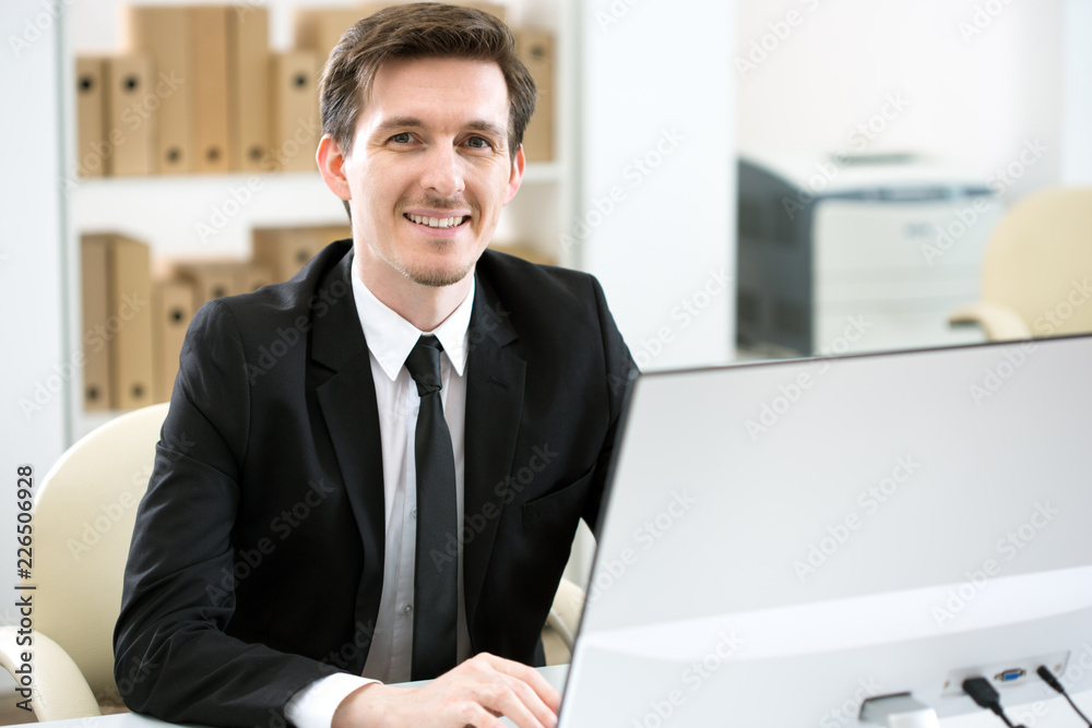 Young handsome businessman working in an office Young handsome businessman working in an office