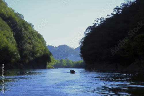 A lone fisherman navigates in your raft on the Usumacinta River in southeastern Mexico. photo