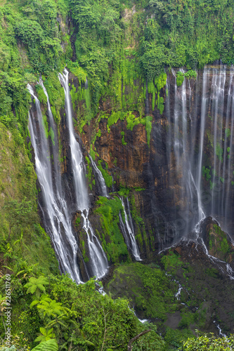 Majestic view of Tumpak Sewu Waterfall or also known as Coban Sewu, is a waterfall with 120 metres high, located in Sidomulyo Village, Pronojiwo District, Lumajang Regency, East Java, Indonesia.