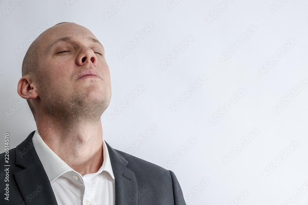 Businessman in suit takes a deep breath and preparing for something big. White background with copy space for text. Businessman in suit takes a deep breath and preparing for something big. White background with copy space for text.