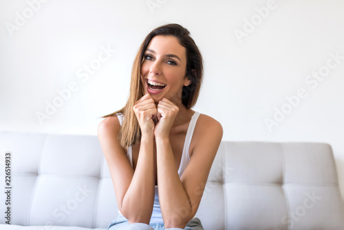 A beautiful young woman being cheerful on the sofa