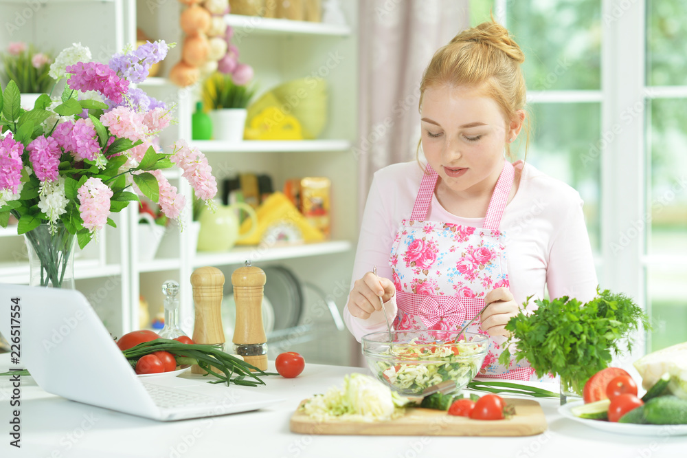 Portrait of teen girl preparing fresh salad