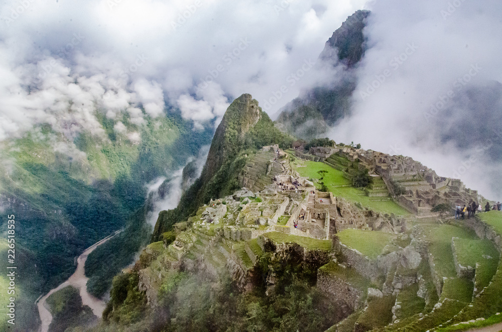 Cloudy morning at Machu Picchu´s starting point in Peru with tourists walking on it