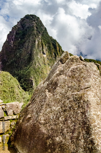 Huayna Picchu simbolic stone and real Huayna Picchu on the back, Machu Picchu, Peru photo