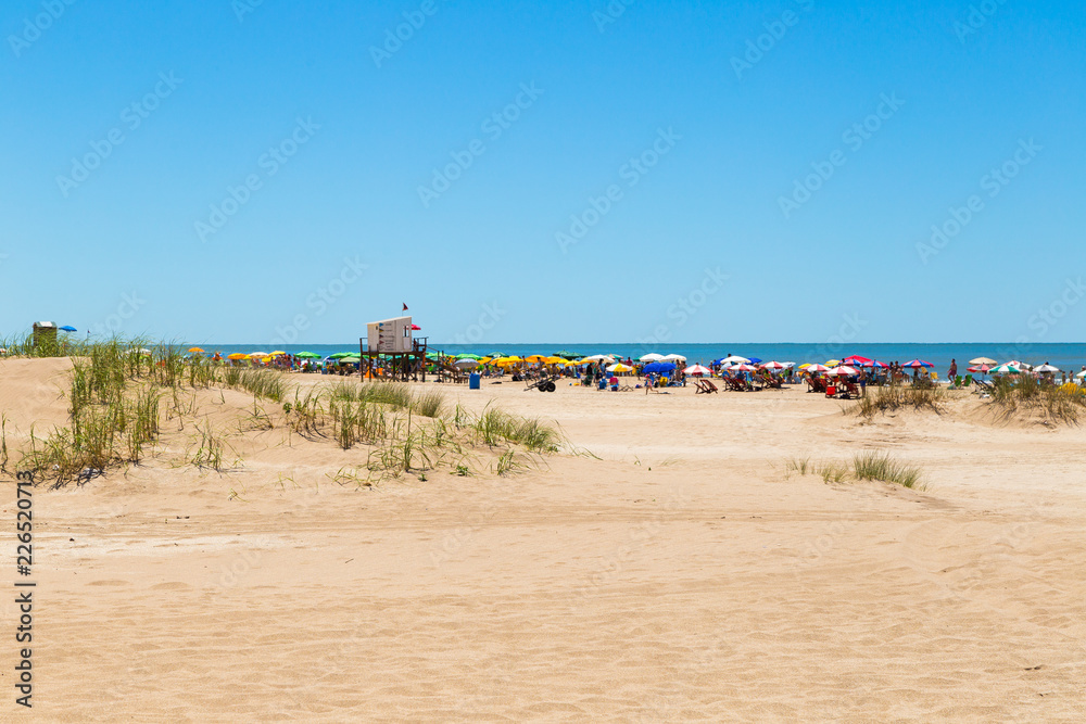 The beach and the sea. View of a beautiful beach in a sunny day of summer. The sky is intense blue.