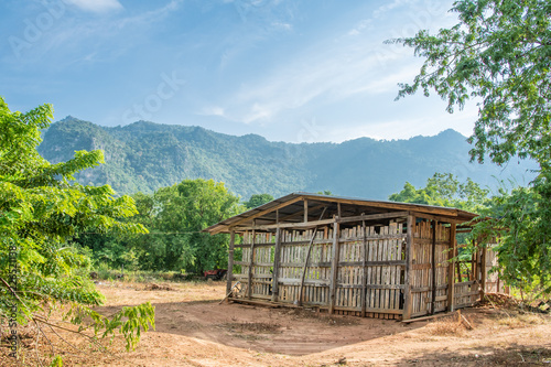 Old hut with mountain background.