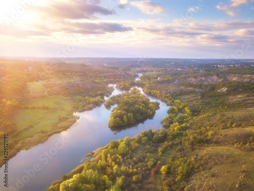 Aerial view of the river and color trees, sunny autumn landscape, drone shot. National park Bugski Guard with picturesque valley and Southern Bug river, Mykolaiv region, Ukraine