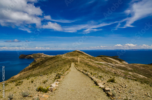 Landscape on Isla del Sol with a blue sky Titikaka Lake and a road © LautaroFederico