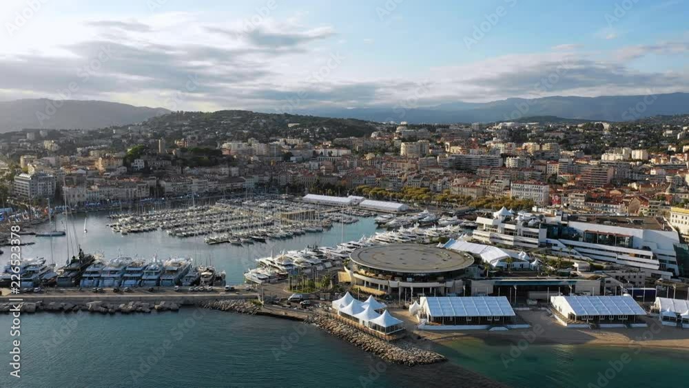 Aerial panoramic view of cityscape of Cannes, famous city on French Riviera during sunset, yachts in harbour - Mediterranean sea, France, Europe Aerial panoramic view of cityscape of Cannes, famous city on French Riviera during sunset, yachts in harbour - Mediterranean sea, France, Europe