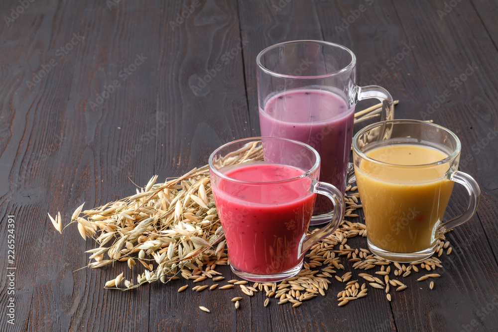 Homemade antioxidant summer fruits smoothie with oats on rustic table