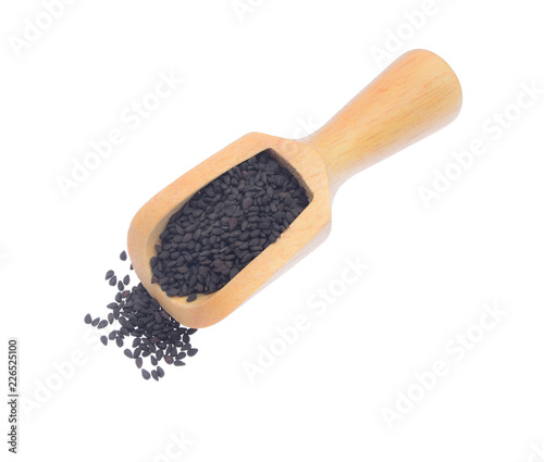 black sesame seeds  in wood scoop isolated on white background