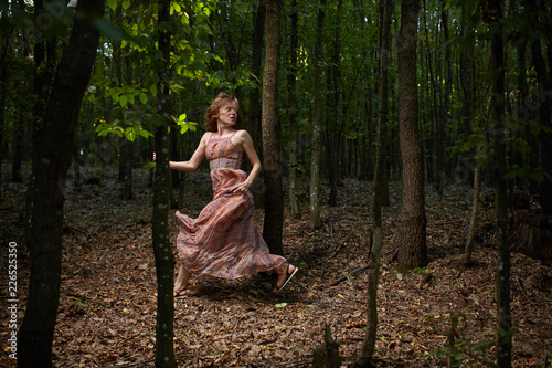 Scared girl running through forest