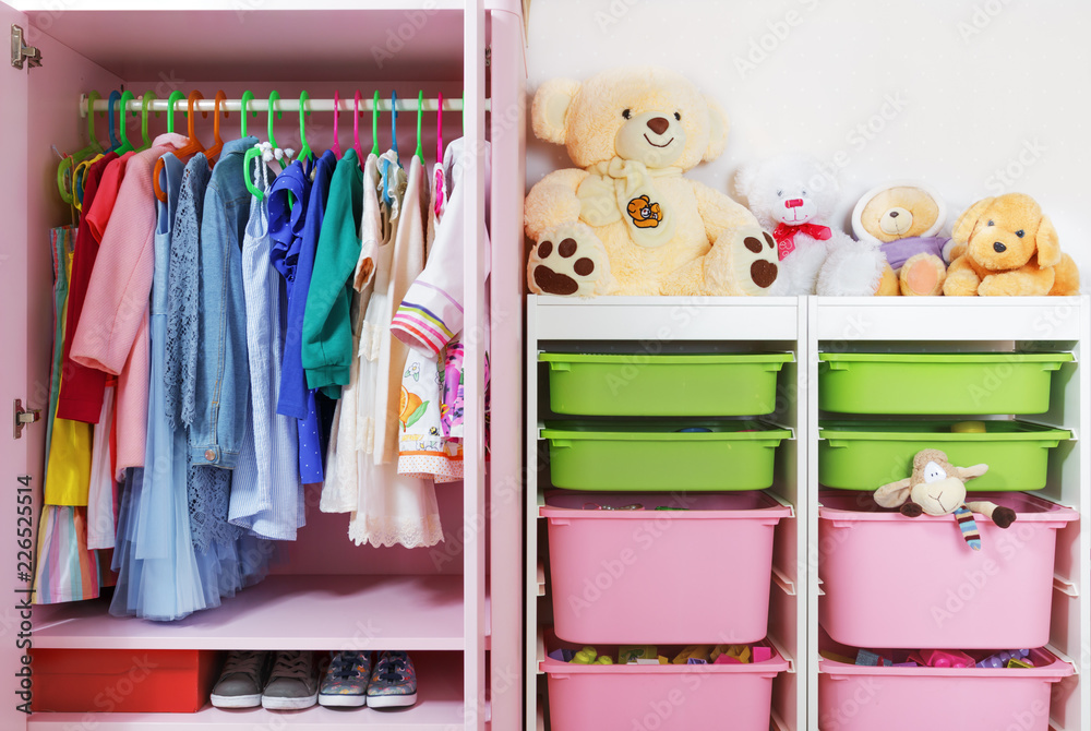 Wardrobe in the children's room. Storage system and storage for the concept of children's things and toys. - obrazy, fototapety, plakaty 