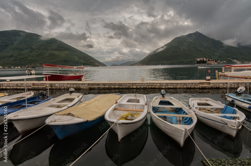 Boats at see before the storm with dramatic clouds in background