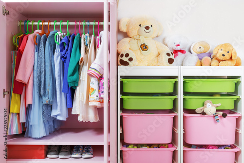 Wardrobe in the children's room. Storage system and storage for the concept of children's things and toys.