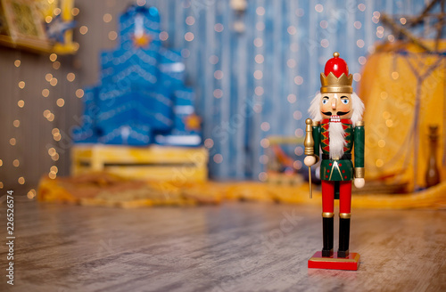 Toy nutcracker on a festive background