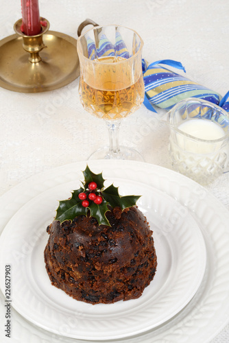 traditional christmas pudding with glass of wine