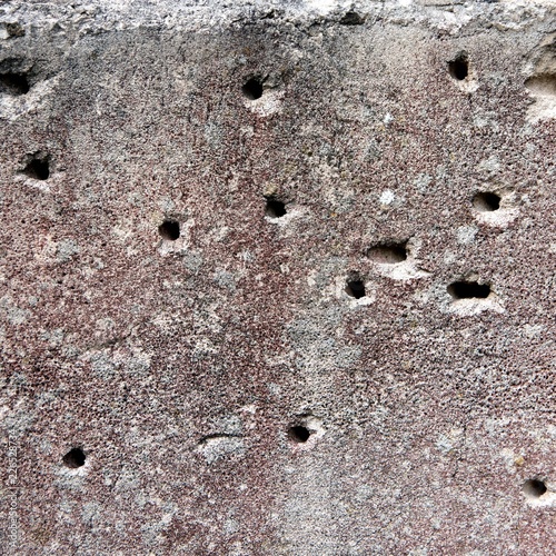 Hole in the destruction concrete wall, bullet hole, abstract background free space for design after war