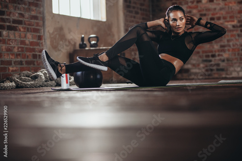 Female in the gym doing abs workout exercise