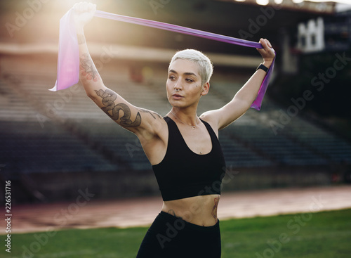 Fitness woman doing workout standing in a stadium