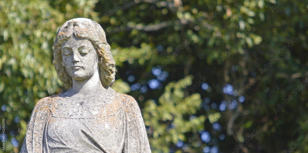 statue of woman in cemetery