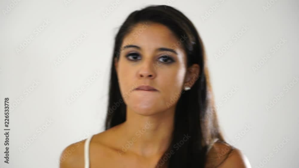 Furious woman being angry as wakes up very early, gestures and shouts loudly with anger, poses against white studio background. Aggressive irritated young female in low spirit in face expression. Furious woman being angry as wakes up very early, gestures and shouts loudly with anger, poses against white studio background. Aggressive irritated young female in low spirit in face expression.