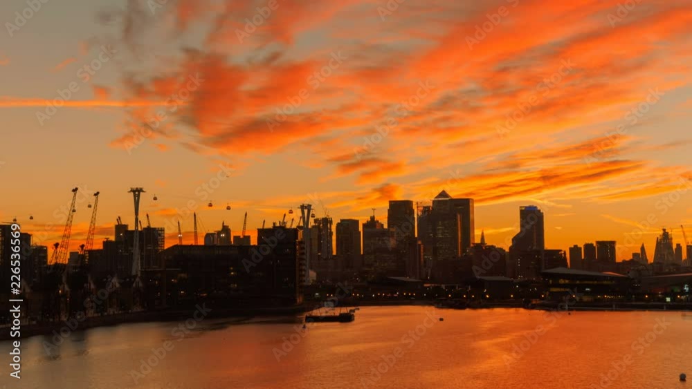 Wide angle shot progressively revealing the City of London under a fiery sky, minutes after sunset Wide angle shot progressively revealing the City of London under a fiery sky, minutes after sunset