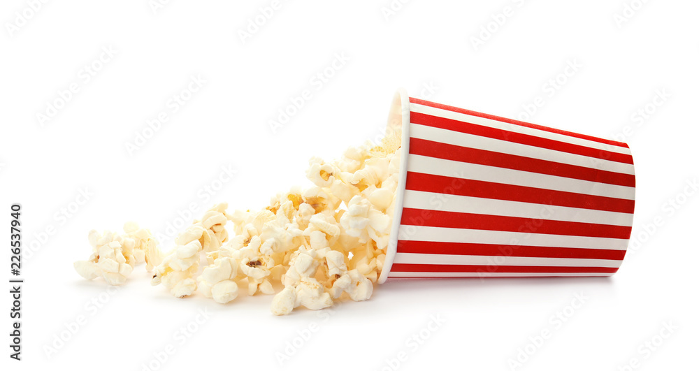 Overturned cup with delicious fresh popcorn on white background