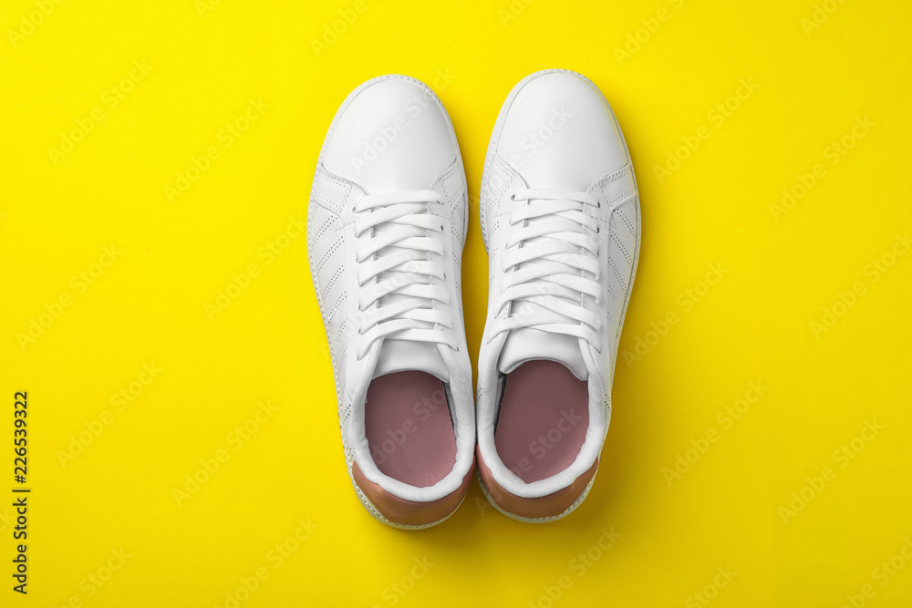 Pair of sneakers on color background, flat lay Pair of sneakers on color background, flat lay