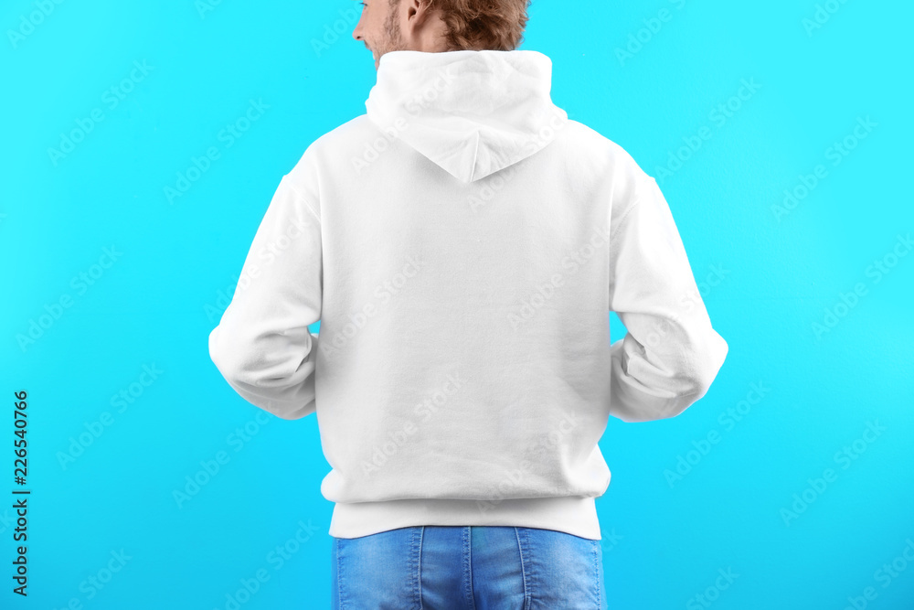 Man in hoodie sweater on color background. Space for design Man in hoodie sweater on color background. Space for design