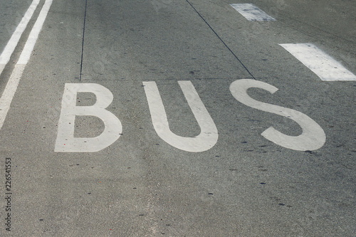 Bus, the inscription on the road. Defines the traffic on the road. Transport.