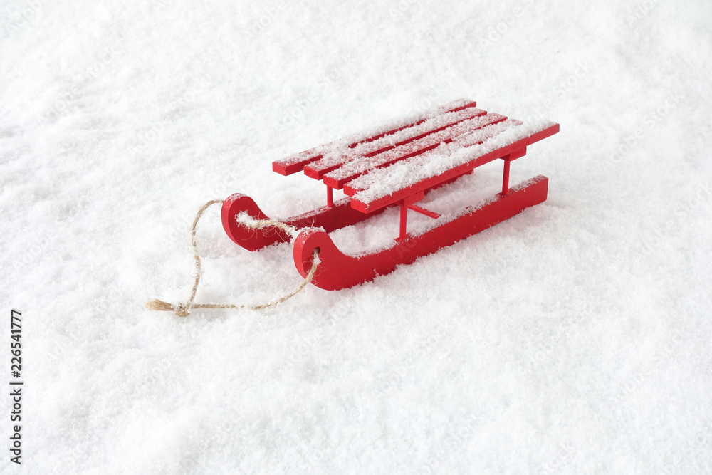 Red Wooden Sledge in Snow covered with Snowflakes - obrazy, fototapety, plakaty 