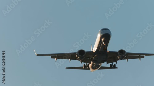 Close-up shot of a large airliner approaching the airport moments before landing on a bright sunny day photo