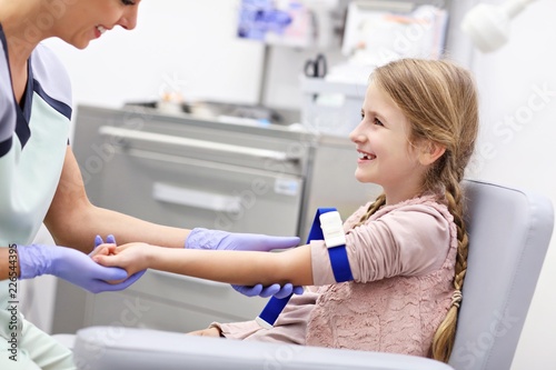 Brave little girl having blood collection for tests © Kalim
