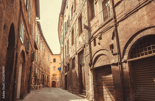 Narrow streets of Siena, brick houses of the ancient town of Tuscany. Historic Centre of italian city, UNESCO World Heritage Site.