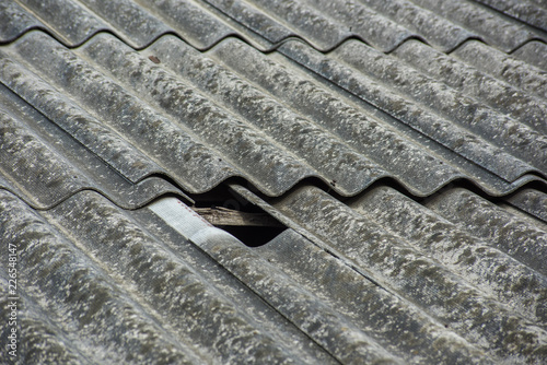 Slate texture on the roof with a broken hole