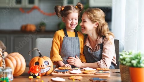 happy Halloween! family mother and daughter getting ready for   holiday and baking cookies