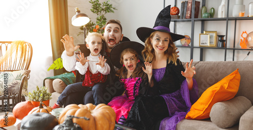 happy family mother father and children in costumes and makeup on Halloween
