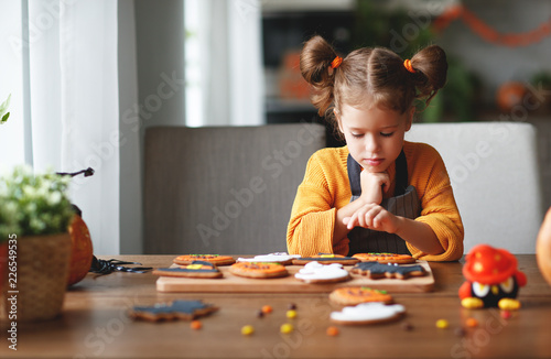 happy child girl in costumes of pumpkins are preparing for holiday Halloween