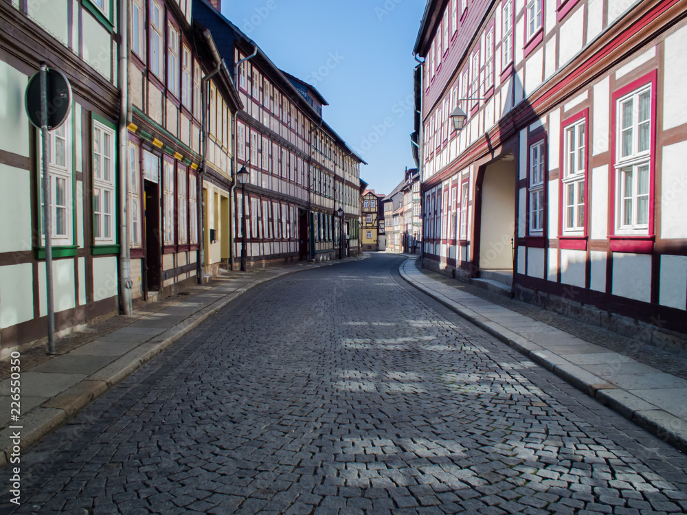 Wernigerode, Germany. Road signs and street lamps on a winding street. Deserted alley in the morning