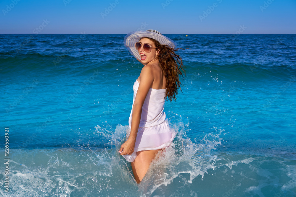 Girl in beach sea shore with waves splash Girl in beach sea shore with waves splash