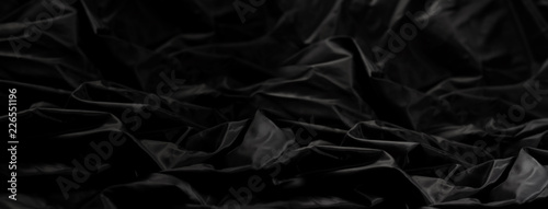 Elegant black satin silk with waves, abstract background