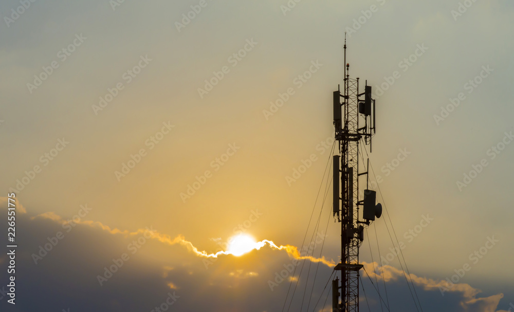 Telecommunication towers with colorful sky backgrounds at sunset