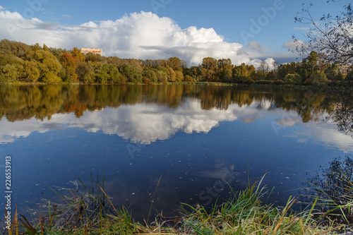 Fall in the park. Autumn trees reflected in the pond of Pokrovskoe-Streshnevo city park, Moscow, Russia. Calm and tranquility. photo