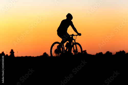 Silhouette of cyclist on the background of beautiful sunset