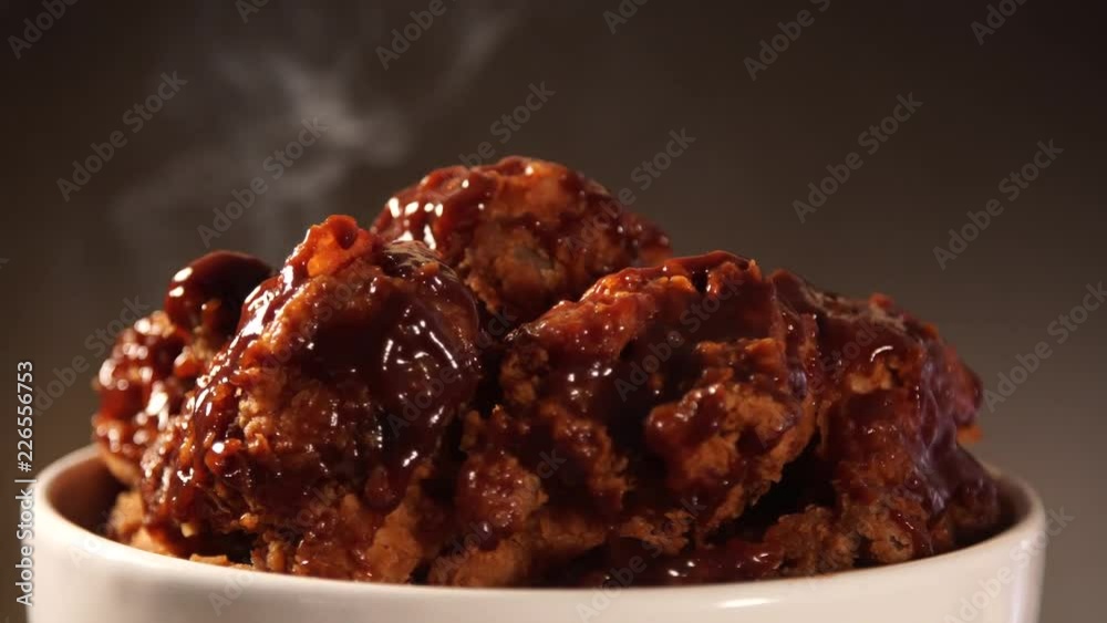 Rotation Bucket full of crispy kentucky fried chicken with smoke on brown background. Rotation Bucket full of crispy kentucky fried chicken with smoke on brown background.