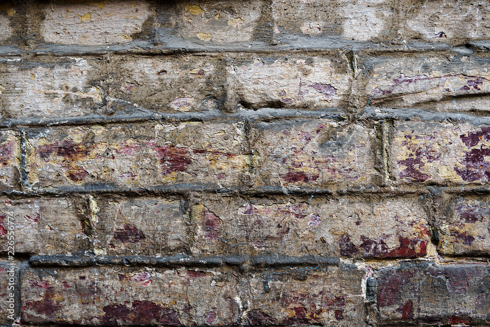 Naklejka premium Old wall of red and white bricks. Background and texture
