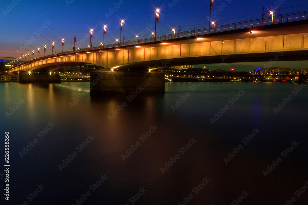 night view of the bridge from the river, Cologne city, Germany, on the banks of the River Rhine.