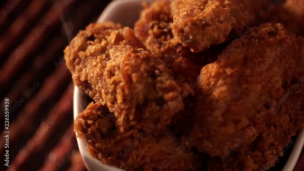 Rotation Bucket full of crispy kentucky fried chicken with smoke on brown background. Rotation Bucket full of crispy kentucky fried chicken with smoke on brown background.
