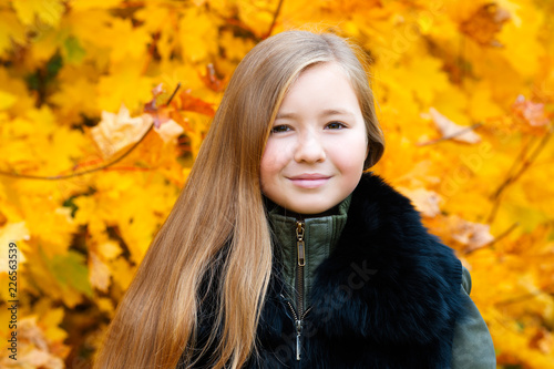 portrait charming girl with long hair in autumn